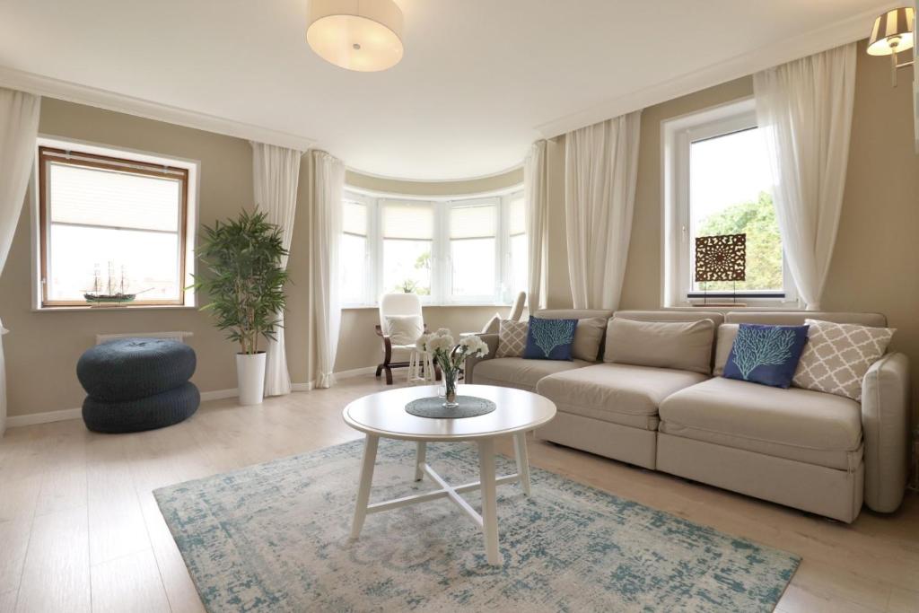 a living room with a couch and a table at Apartbaltic - Monte Cassino in Świnoujście