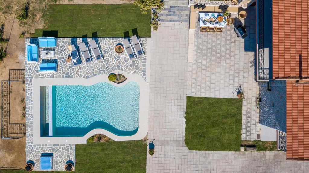 an overhead view of a swimming pool next to a house at Emarmene Home with private pool near Rhodes Town & airport in Koskinou