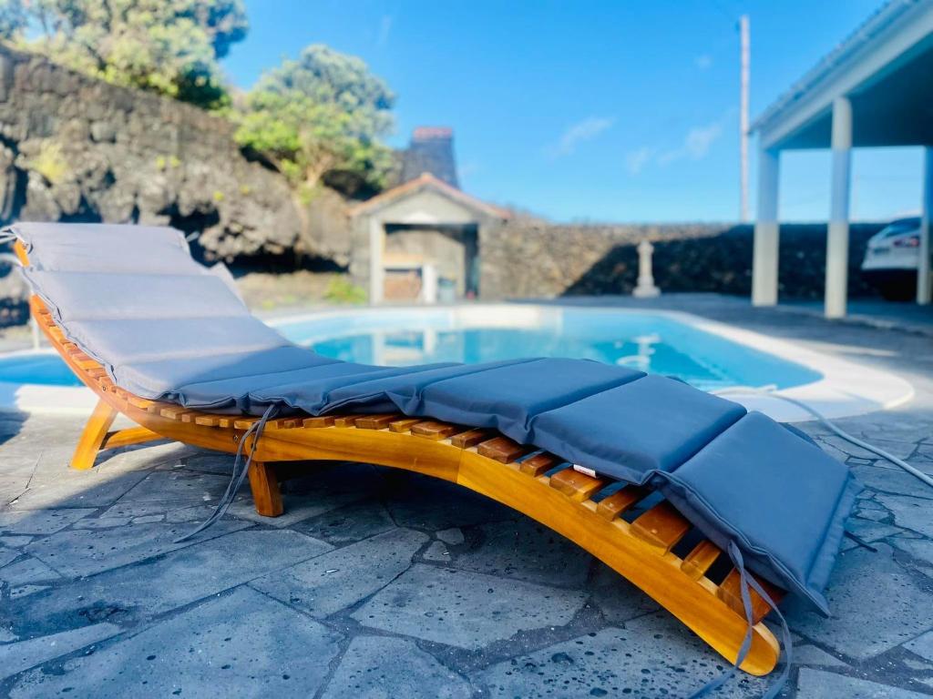 a chaise lounge next to a swimming pool at Casa Flor de Sal in São Mateus