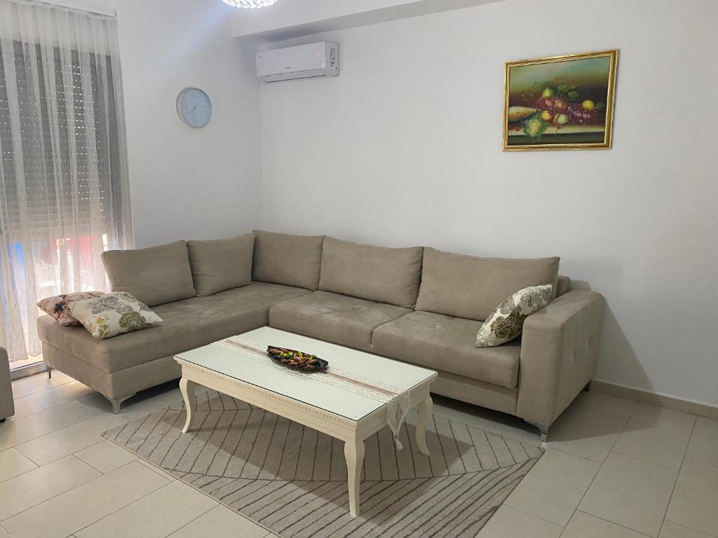 a living room with a couch and a coffee table at Diar Apartment in Durrës