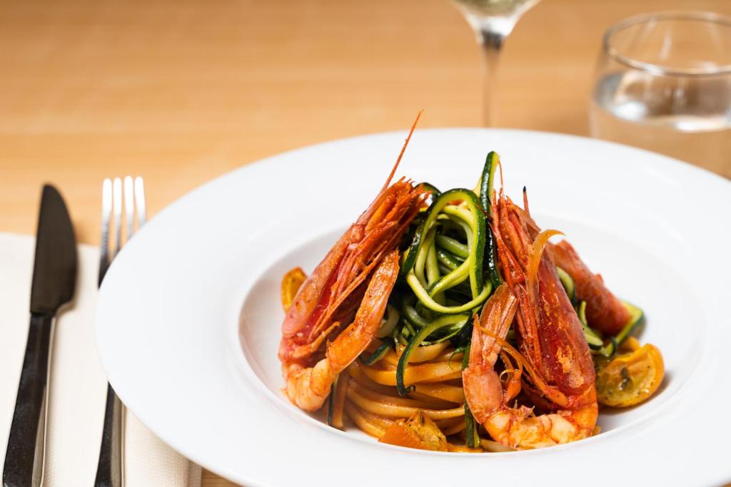a white plate of food on a table at Hotel dP Olbia - Sardinia in Olbia