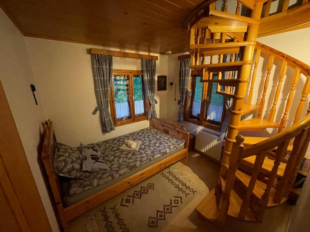 a room with a bunk bed in a house at Hiša pod Rogatcem in Luče