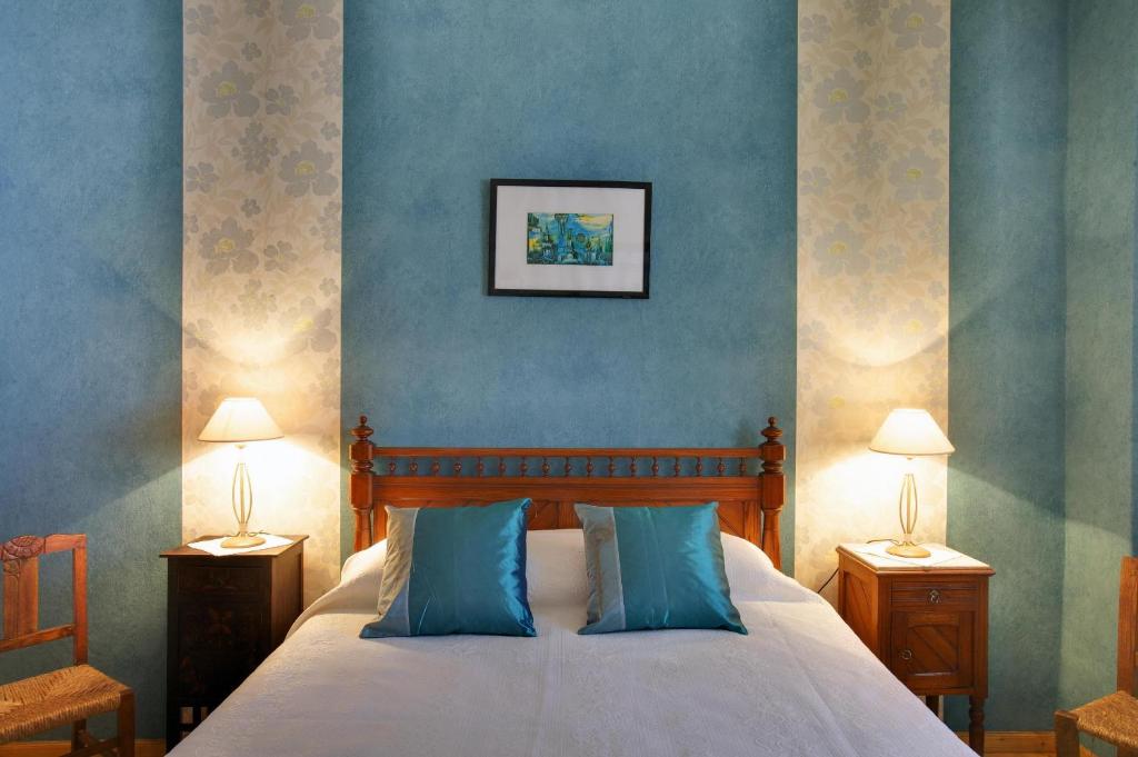 ein Schlafzimmer mit einem Bett mit blauen Wänden und 2 Lampen in der Unterkunft Hospedaria Moiras Encantadas in Paderne