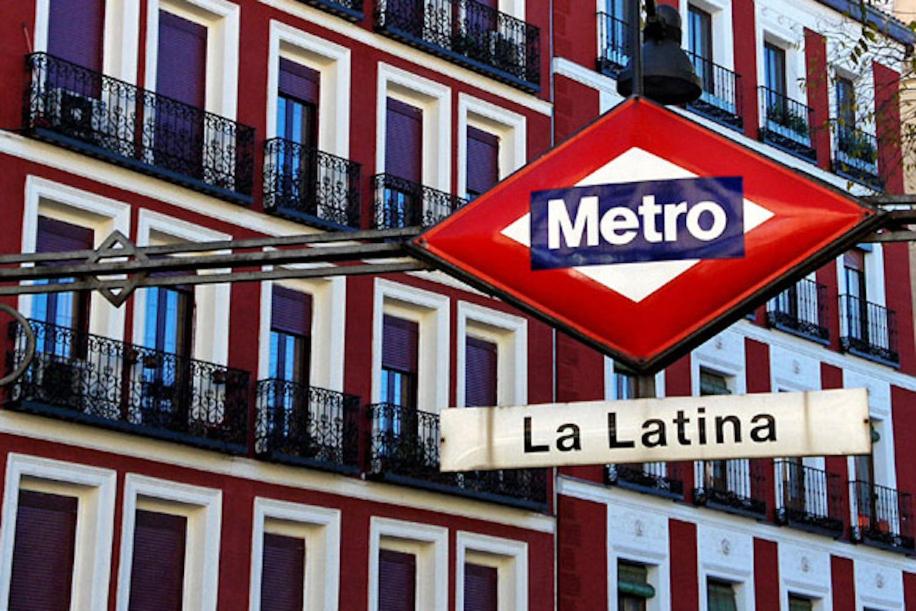 a red metro sign on the side of a building at Madrid Citymad Six in Madrid
