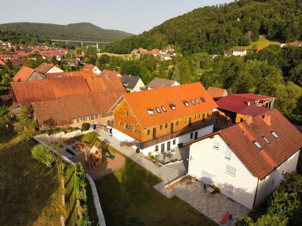an aerial view of a house with orange roofs at Belzesaltescheune 4 Sterne Ferienwohnung in Riedenberg