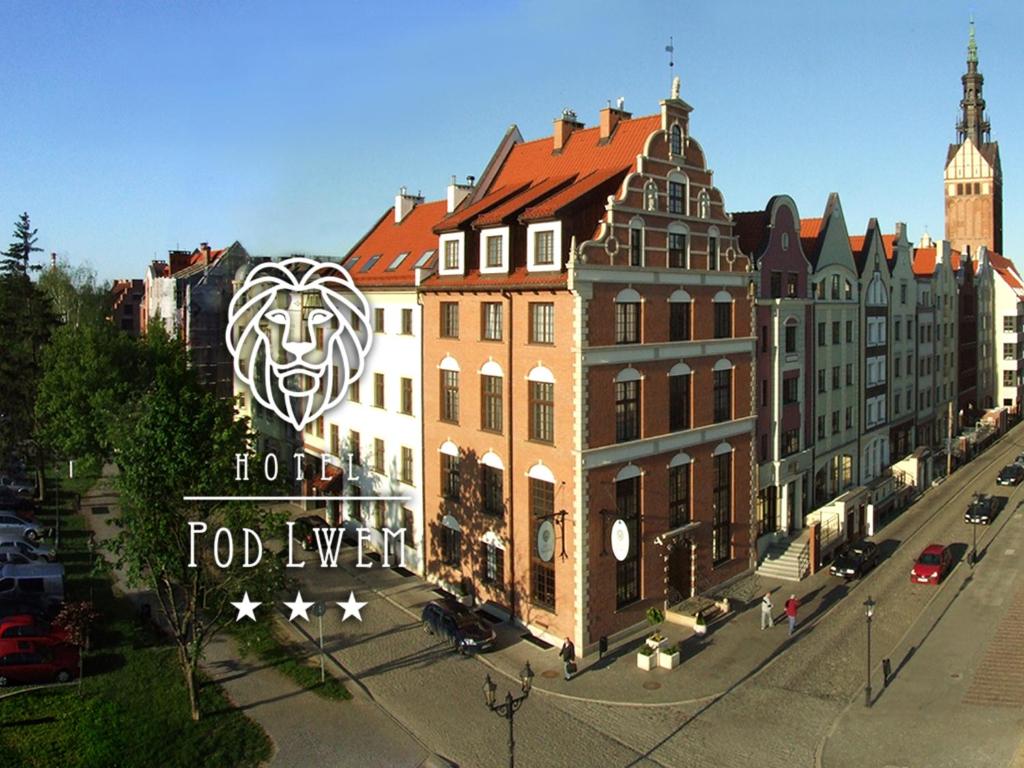 a large building with a lion on the side of it at Hotel Pod Lwem in Elblag