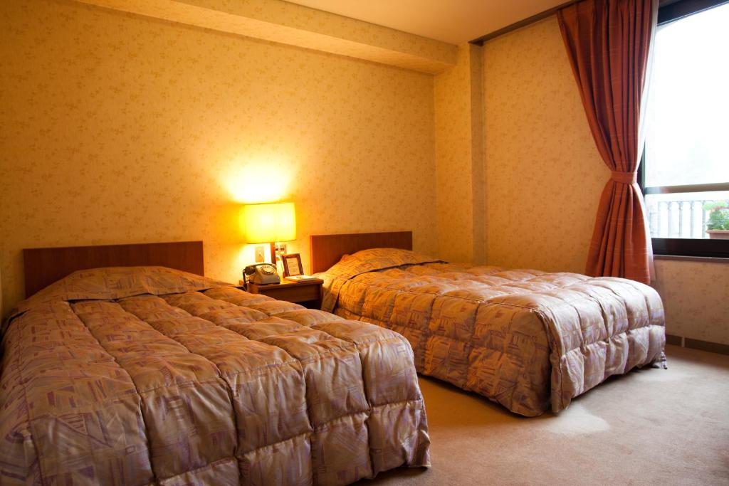 Postel nebo postele na pokoji v ubytování Shiga Kogen Hotel Shiga Sunvalley