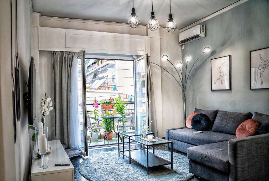 a living room with a couch and a table at Lux apartment near Acropolis! in the Heart of Athens in Athens