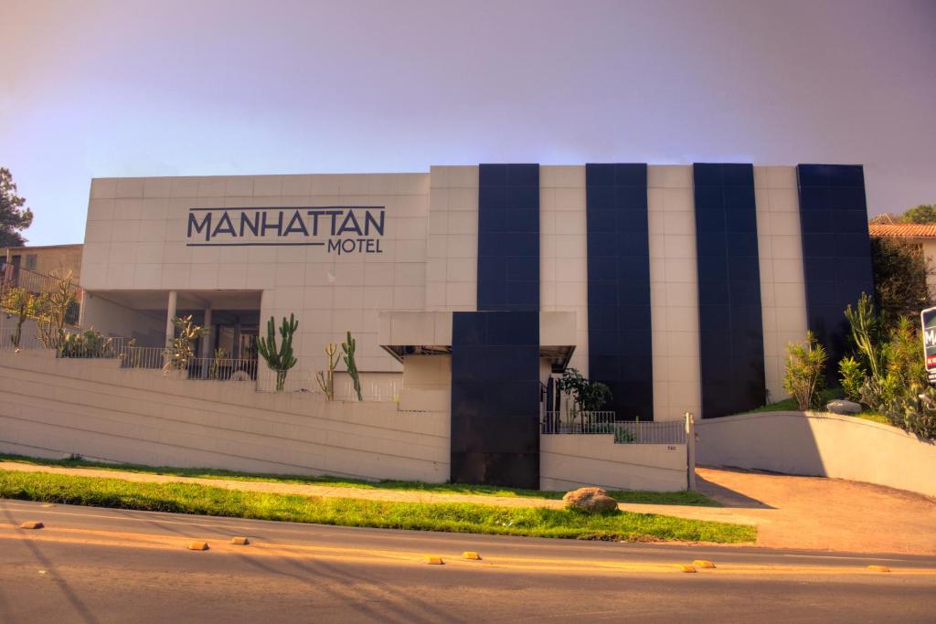 a building with a sign on the side of it at Manhattan Motel (Adult Only) in Porto Alegre