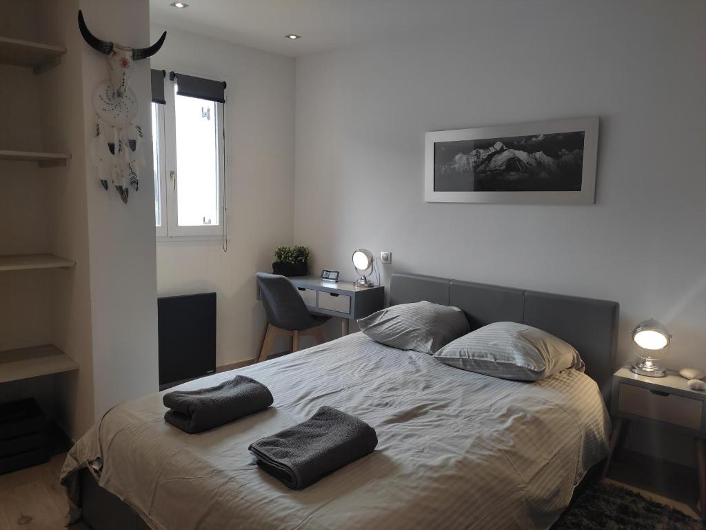 a bedroom with a bed with two pillows on it at Central Sweet Home in Saint-Gervais-les-Bains