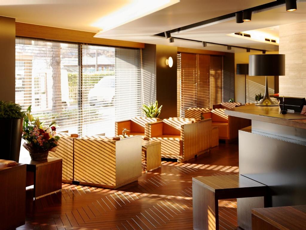 ein Restaurant mit Stühlen und Tischen und einem großen Fenster in der Unterkunft Central Hotel Okayama in Okayama