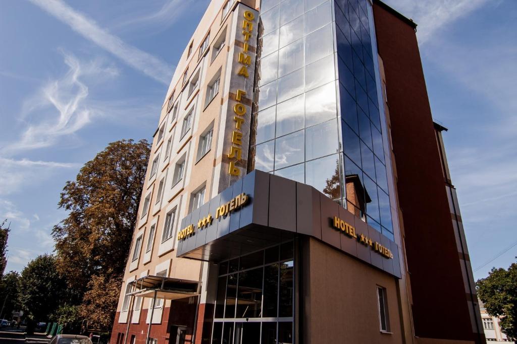 a building with a sign on the front of it at Optima Rivne in Rivne