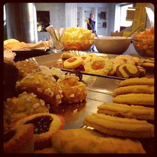 a table with a bunch of different types of pastries at Hotel Italia in Carmagnola