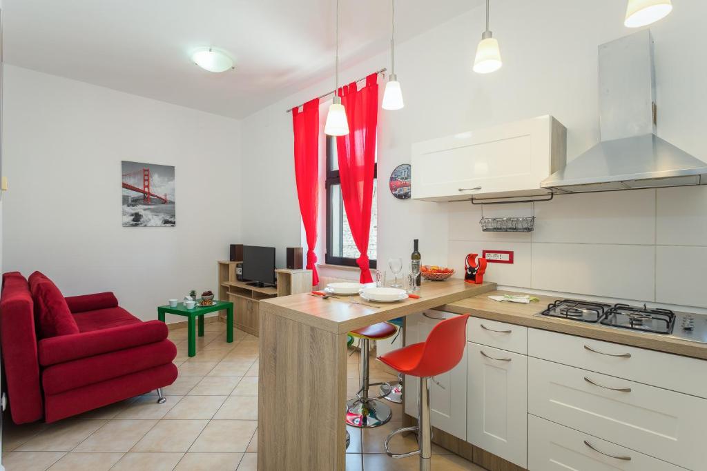 a kitchen with a red chair and a kitchen counter at Mimi in Pula
