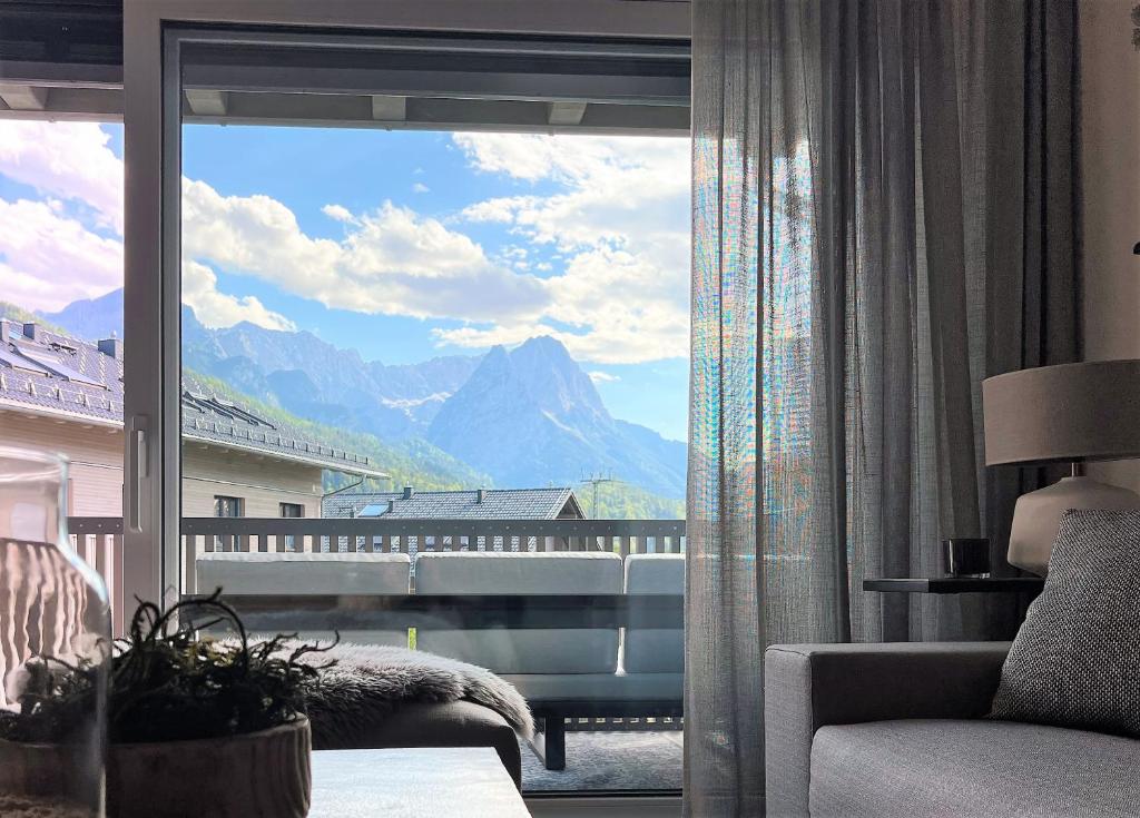 a room with a large window with a view of a mountain at BergCrystal in Garmisch-Partenkirchen