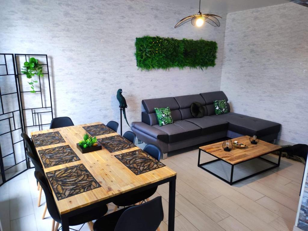 a living room with a couch and a table at Zoologîte in Saint-Aignan