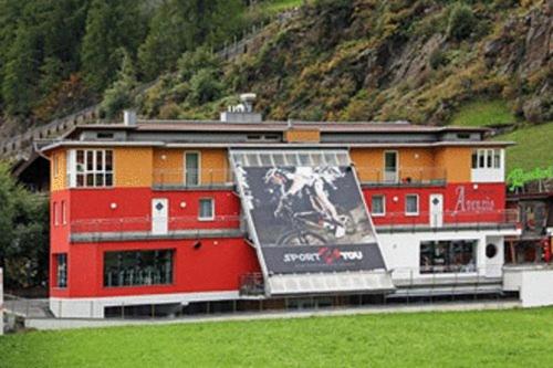 a building with a mural on the side of it at Appartements Avenzio in Sölden
