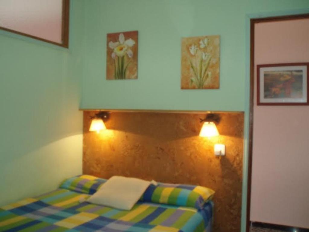 a bedroom with a bed and two pictures on the wall at Apartment - 1 Bedroom with WiFi and Sea views - 01990 in Las Marciegas