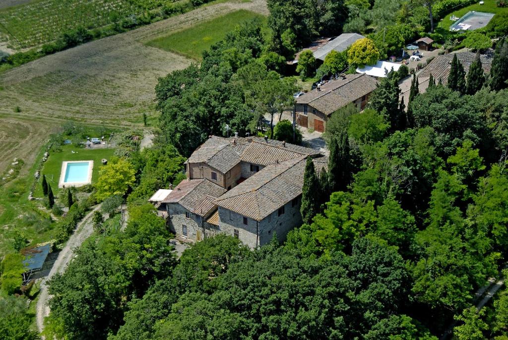 an aerial view of a house in the trees at La Rocca della Magione in Monteriggioni