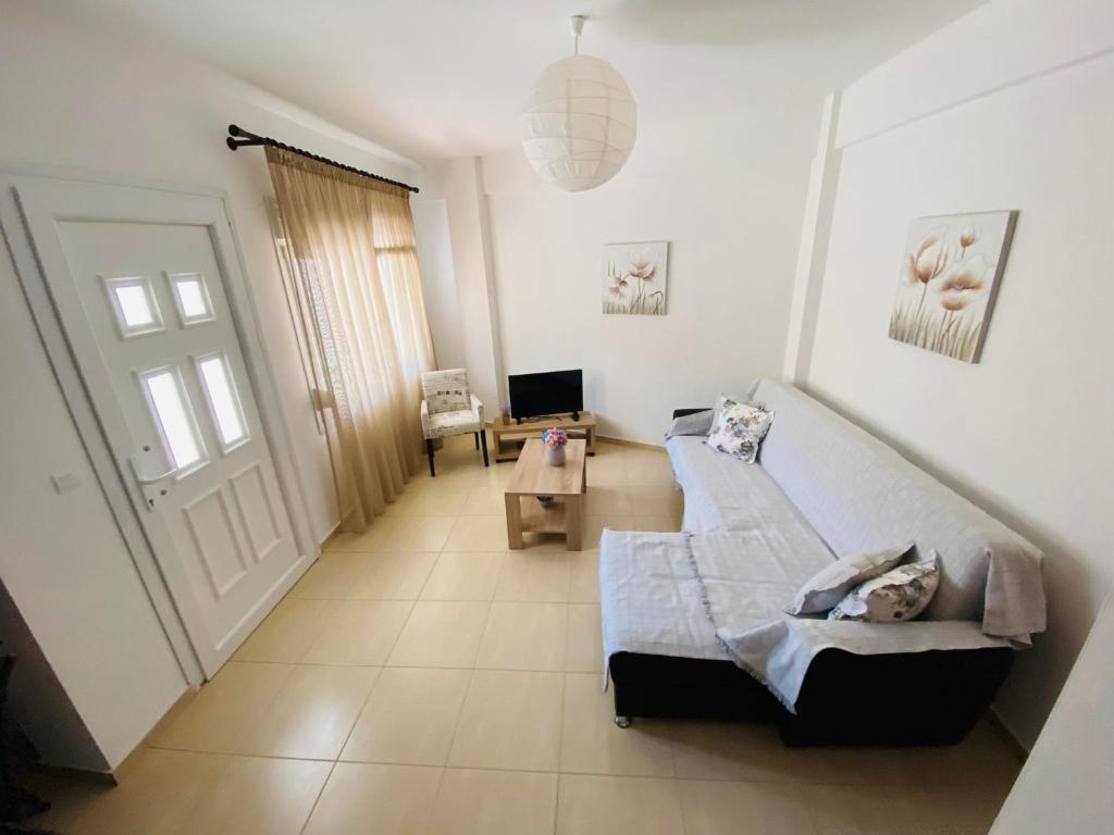a living room with a bed and a door at Chrisa's Guest House in Skala Potamias