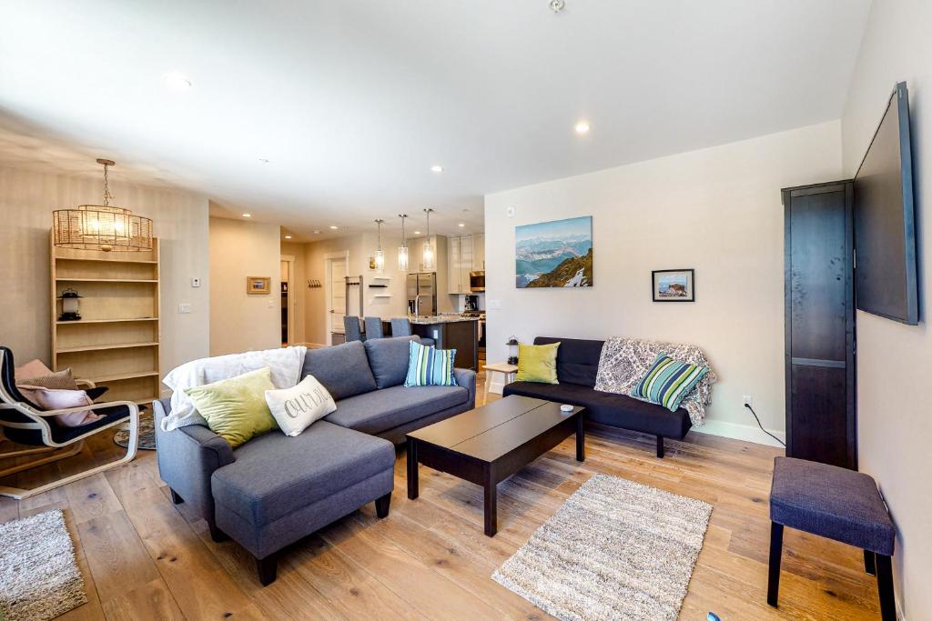 a living room with a couch and a table at Brand New Boardwalk Getaway in Grand Lake