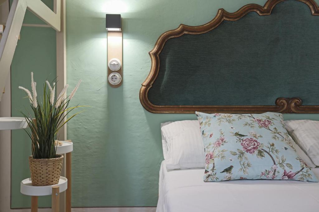 - une chambre dotée d'un lit avec un mur vert dans l'établissement Donna Elena - Epoque Residence, à Asti