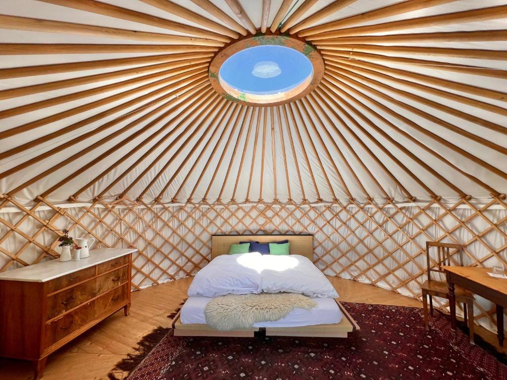 a room with a bed in a yurt with a window at Alp Jurte Skihütte Feldis in Feldis