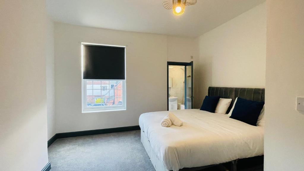 a bedroom with a bed and a window at YO ROOM! Apartments- Next to City Centre Apartment - With Free Parking in Leicester