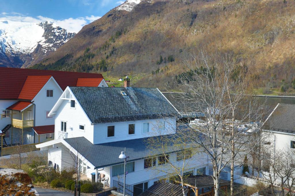 a group of houses in front of a mountain at Svingen Apartments in Balestrand