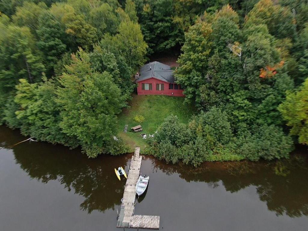 an aerial view of a house on an island in the water at Tranquility On Teal Lake in Hayward