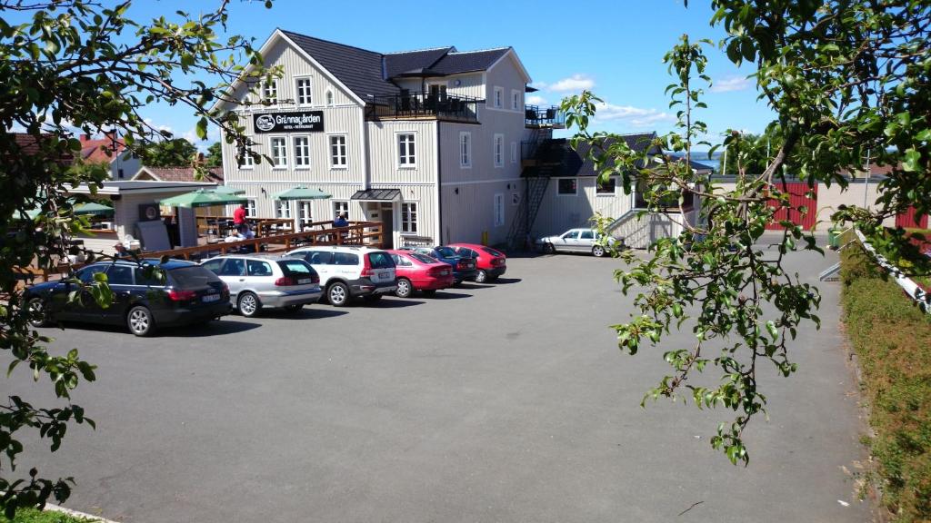 a parking lot with cars parked in front of a building at Grännagården in Gränna