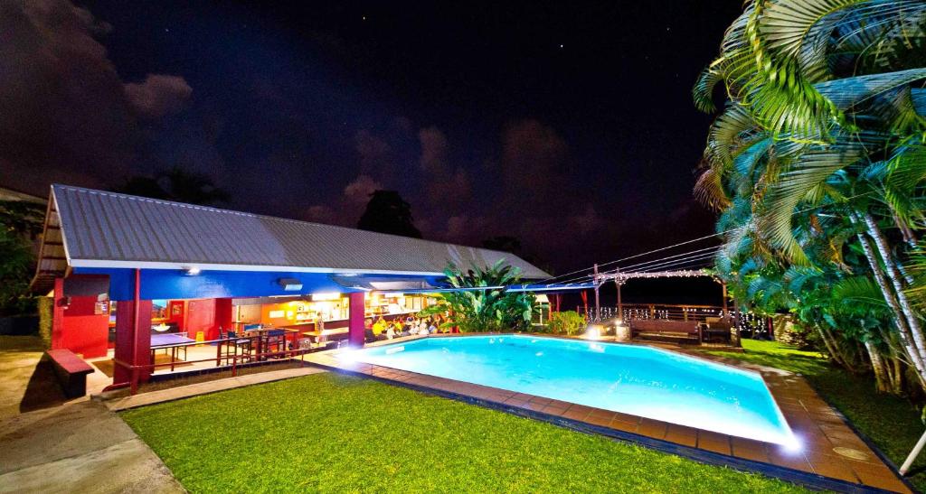 a swimming pool in front of a house at night at Retreat Seaside in Port Vila