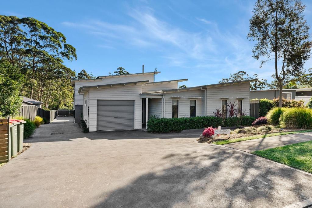a house with a driveway in front of it at The Oasis of Calm by Experience Jervis Bay in Huskisson