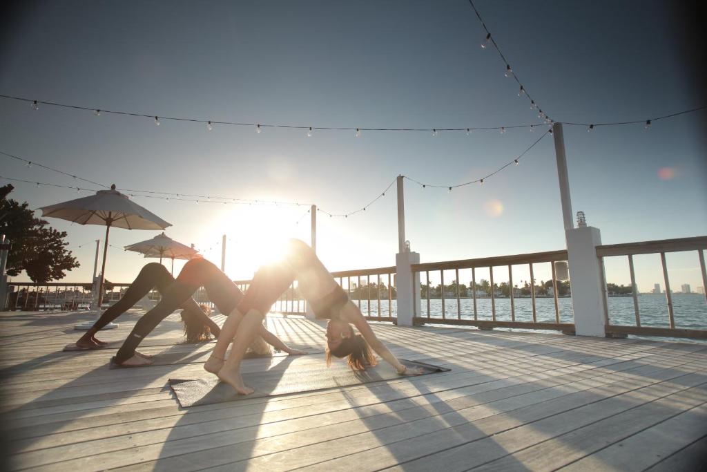 two women are laying on a pier near the water at The Standard Miami in Miami Beach