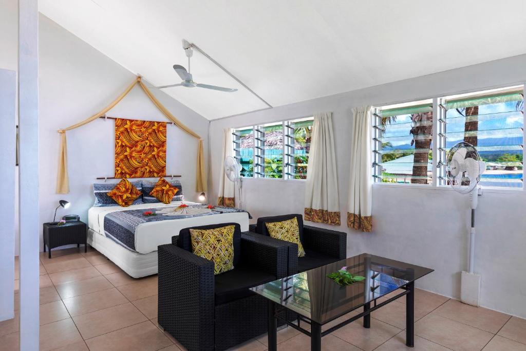 a bedroom with a bed and a table at Savaii Lagoon Resort in Fagamalo