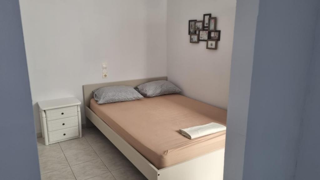 a small bedroom with a bed and a night stand at Seaside appartment to enjoy,relax with great view in Gázion