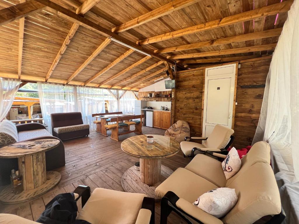 a living room with a couch and a table at Каравана Чайка in Sozopol