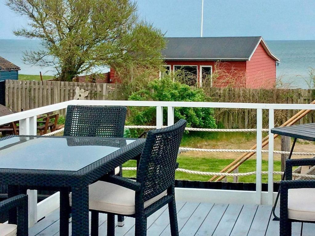 a patio with a table and chairs on a deck at 6 person holiday home in Otterup-By Traum in Otterup