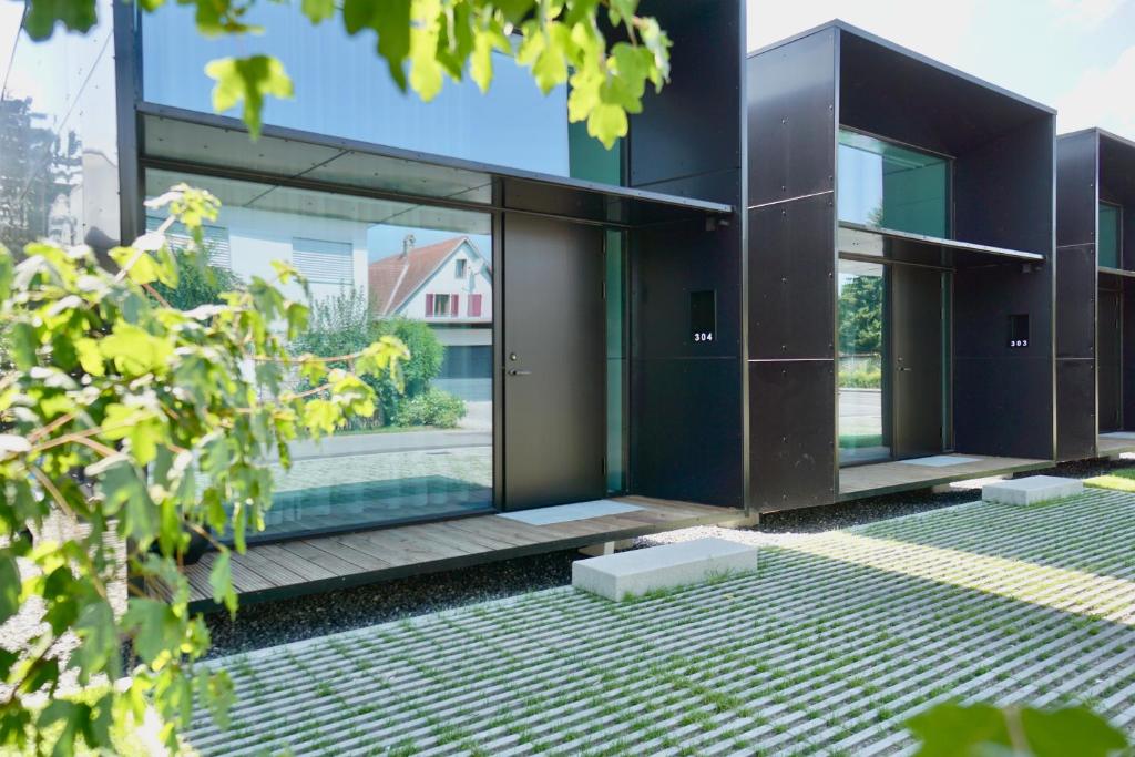 - une vue extérieure sur une maison dotée de portes en verre dans l'établissement Chalet Park by Maier Mäder, à Mäder