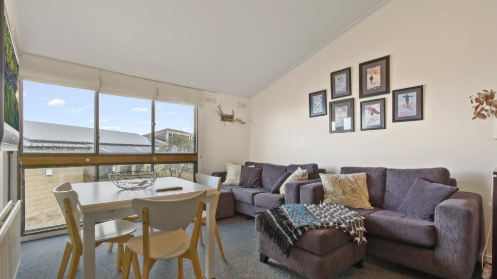 a living room with a couch and a table at Shamrock 3 in Mount Hotham