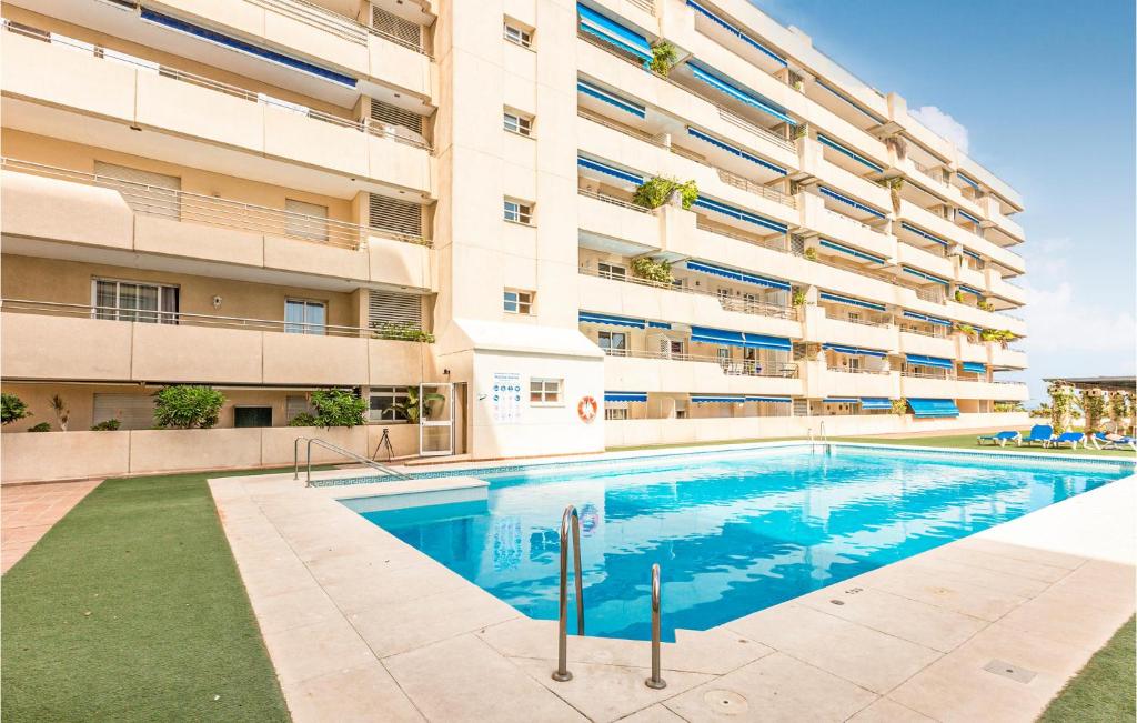 a swimming pool in front of a building at 1 Bedroom Cozy Apartment In Marbella in Marbella