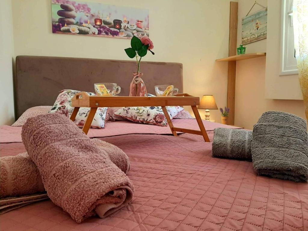 a bedroom with a bed with a table on it at Central Square appartment with panoramic view in Kalamata