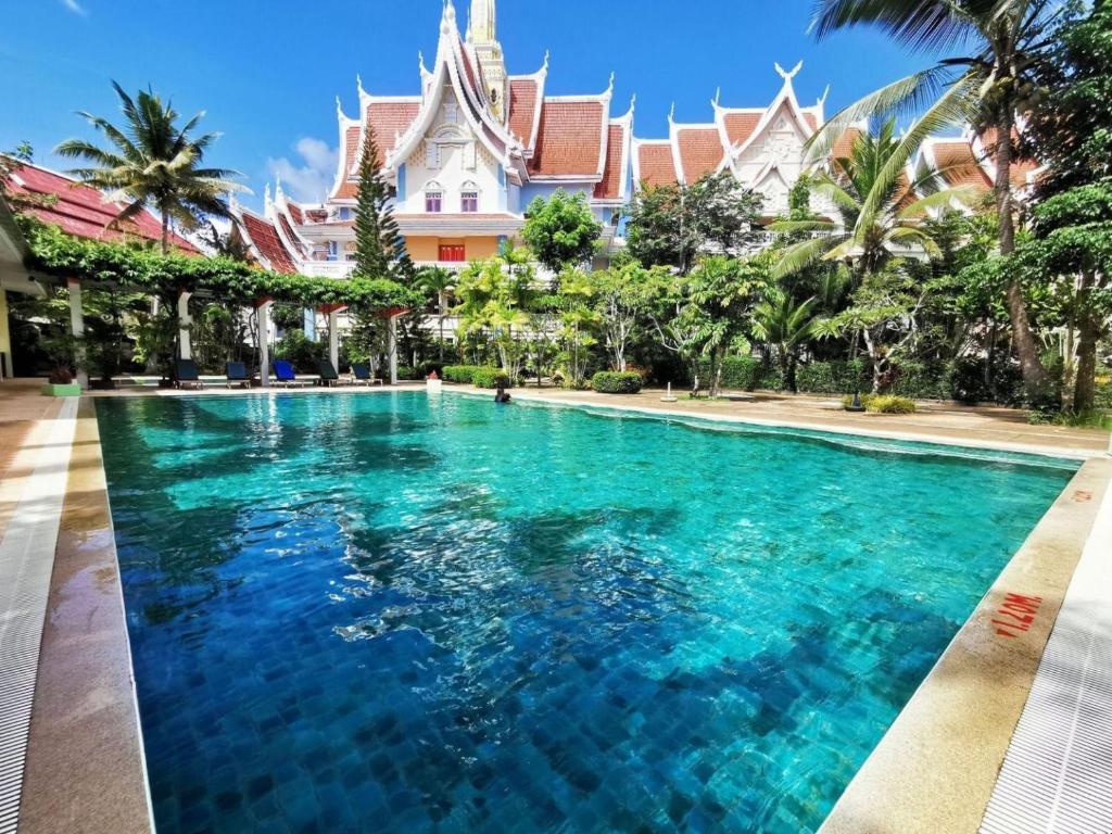 a swimming pool in front of a resort at Ayodhaya Palace Beach Resort-Family run -SHA Plus certified in Ao Nang Beach
