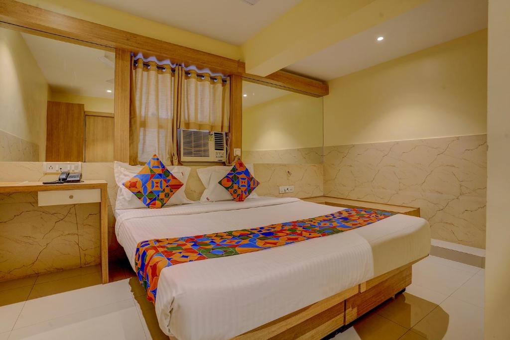 a bedroom with a large bed in a room at FabHotel Starwood Residency in Navi Mumbai