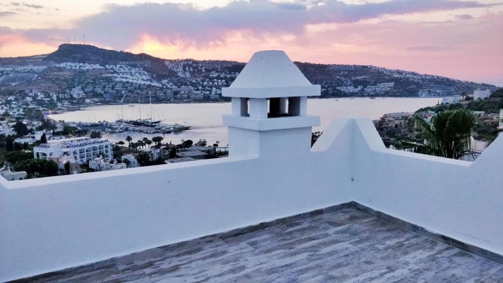 a view from the balcony of a house with a view of a harbor at Bodrum Gündoğan Koyu Havuzlu Site in Bodrum City