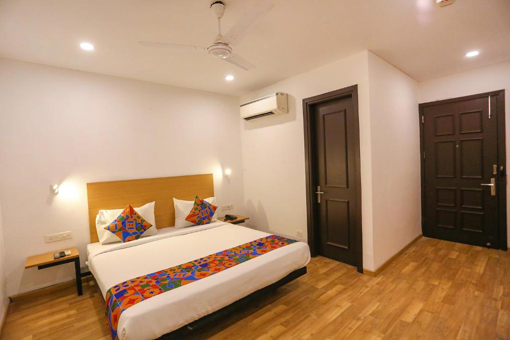 a bedroom with a large bed in a room at FabHotel A One Paschim Vihar in New Delhi