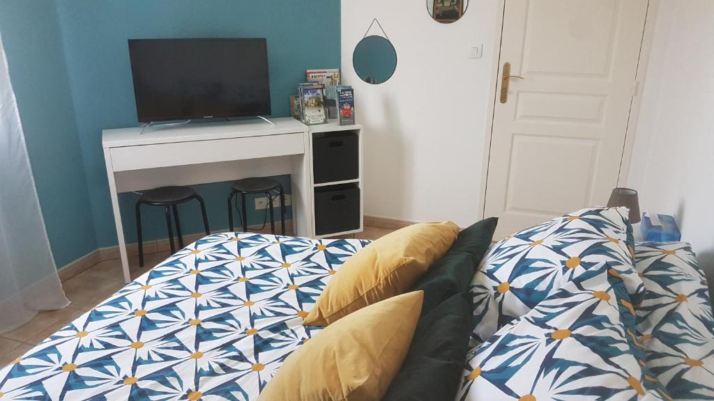 Televízia a/alebo spoločenská miestnosť v ubytovaní Chambre privée des 2 Clochers