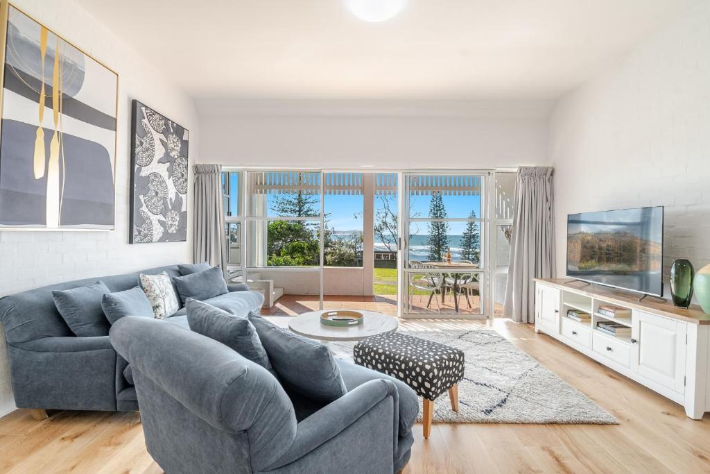 a living room with a couch and a table at Quarterdeck Unit 2 - Lennox Head in Lennox Head