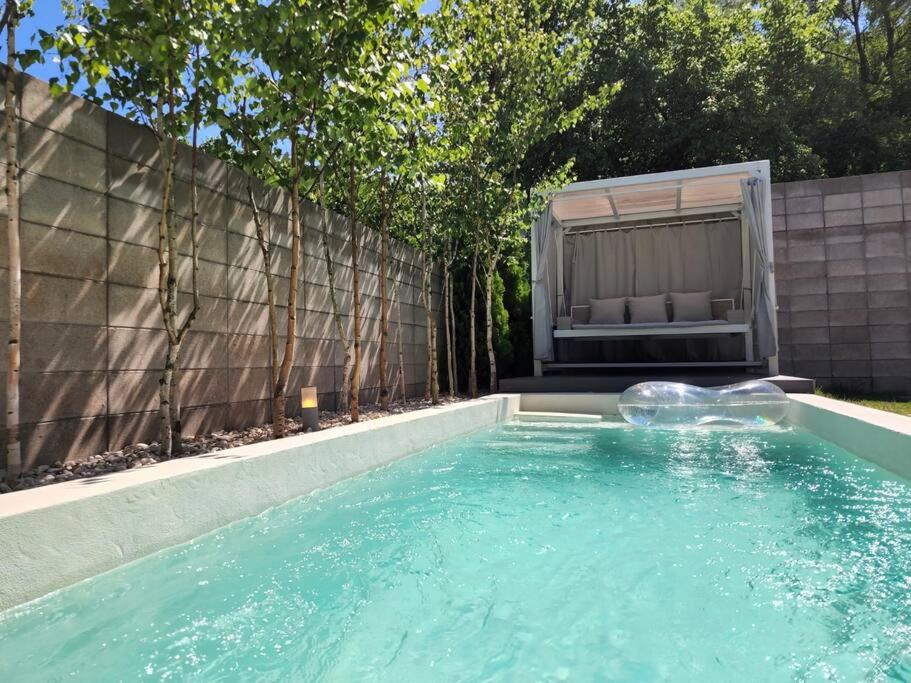 a swimming pool with a couch in a backyard at PPP Seoul in Seoul