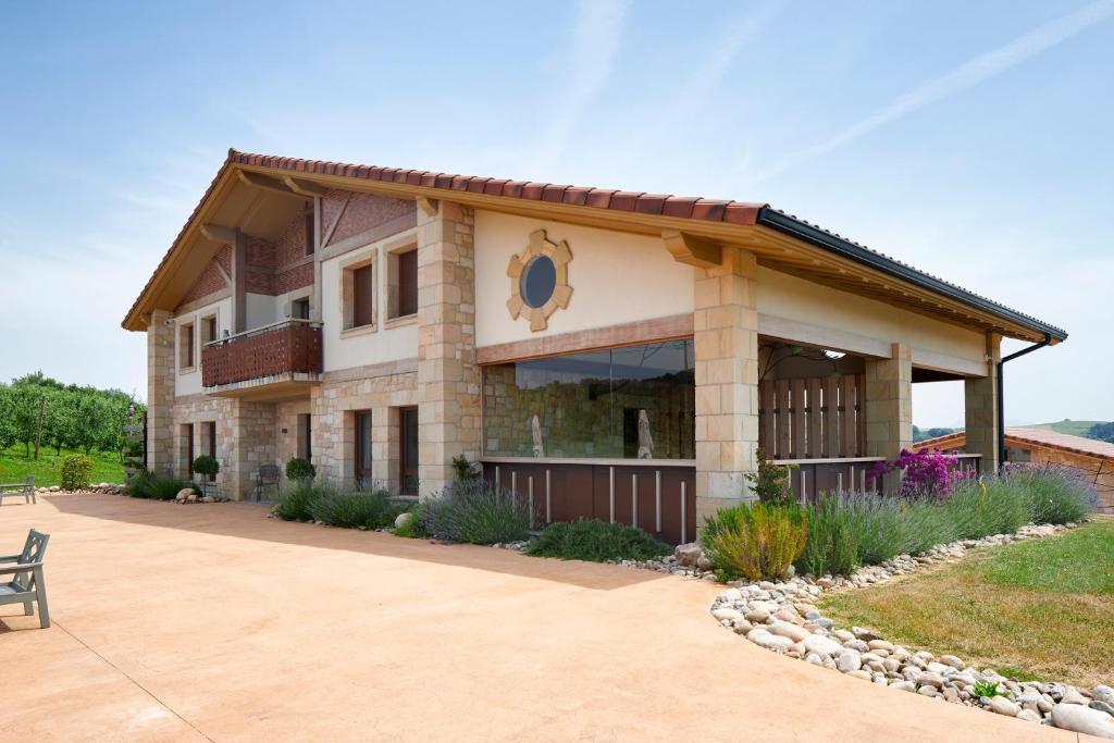 a house with a bench in front of it at Olivi1948 - Boutique Guest House in Usúrbil